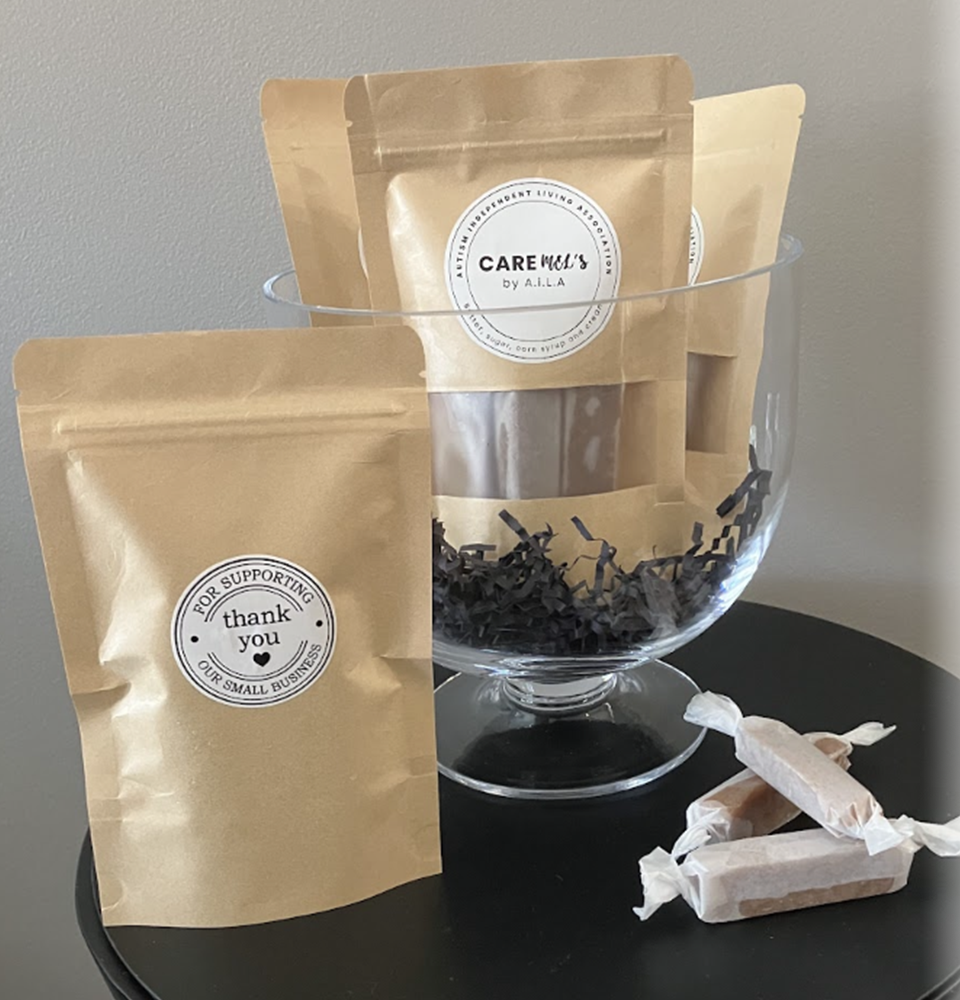 SocialEnterpriseInitiativePage-1 2 bags of CAREmels on a black table with a few CAREmels displayed beside them